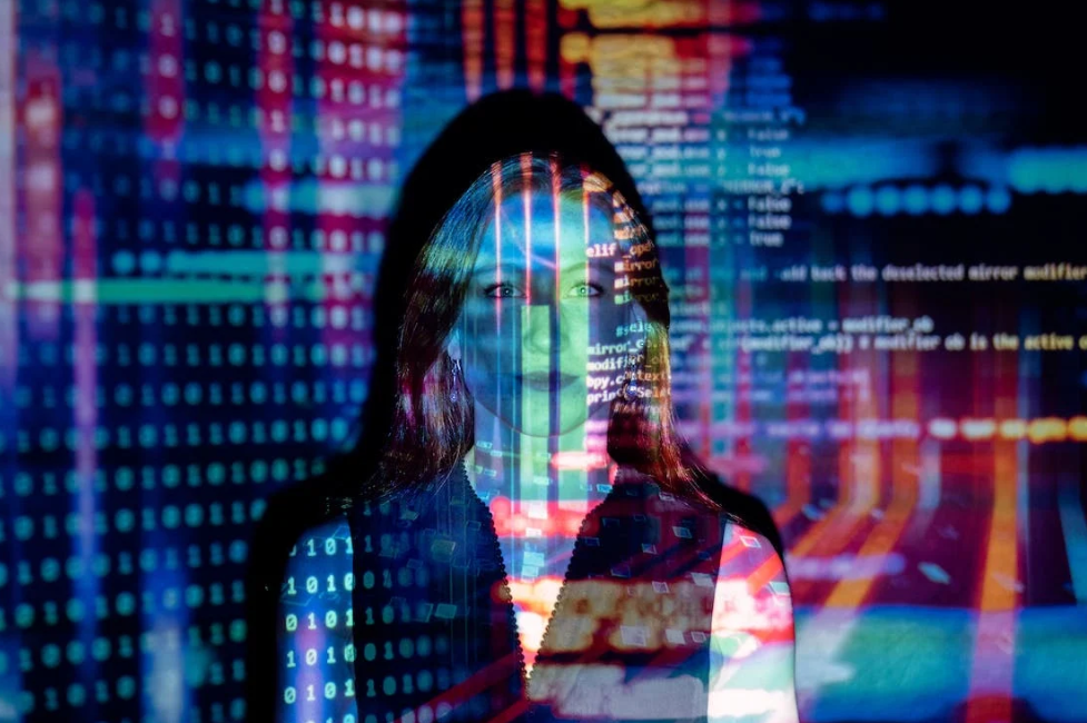 image of a woman to against a computer screen to illustrate KYC for the sandbox